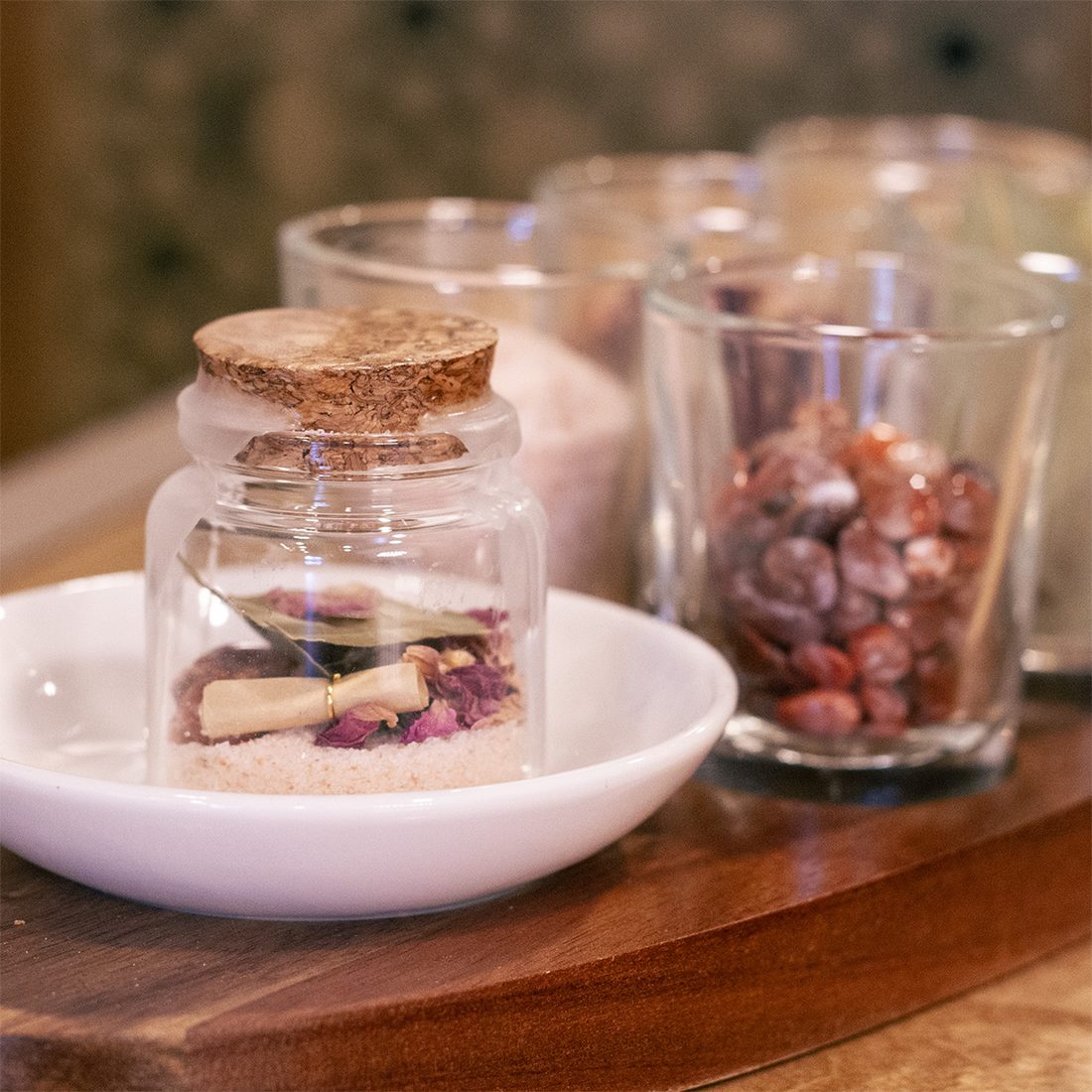 A corked spell jar with herbs and petals from the Virgo Room spell jar bar